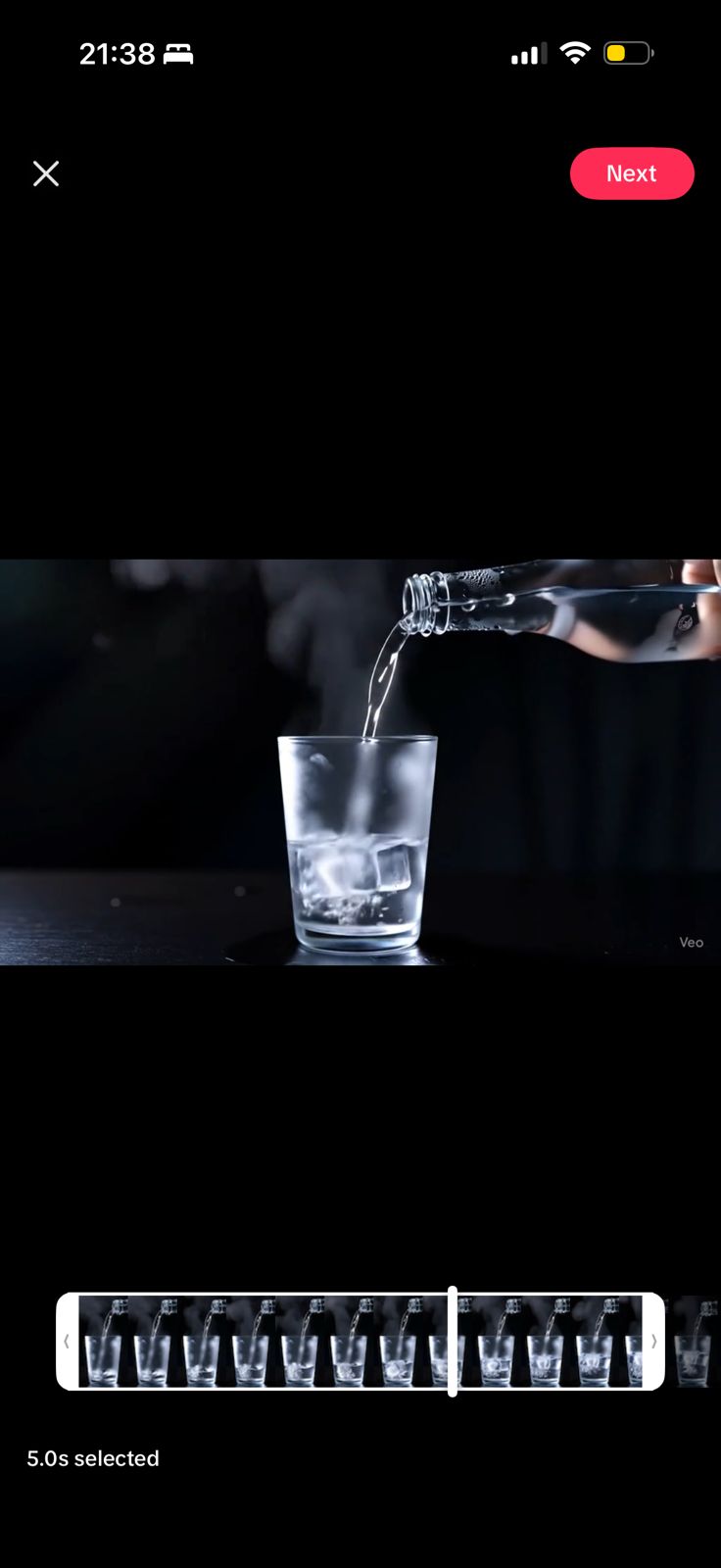 Pure water being poured into a glass with ice